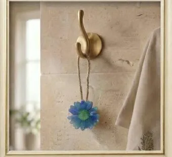 Blue Daisy Wall Hanging Soap — A handcrafted daisy-shaped soap with a brass hook.