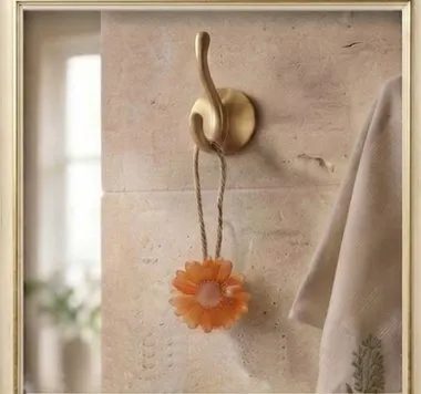 Orange Daisy Wall Hanging Soap — A handcrafted daisy-shaped soap with a brass hook.